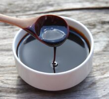 Ramekin of Blackstrap molasses with dripping spoon