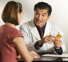 a doctor explains taking a medication to a female patient