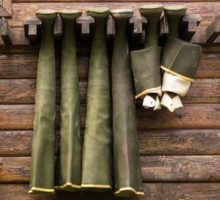 Hip waders hanging up to dry on outside of cabin wall could lead to swamp rash