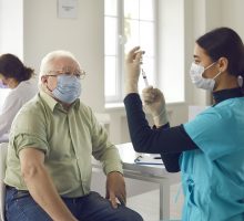 Older person getting a COVID-19 vaccine booster
