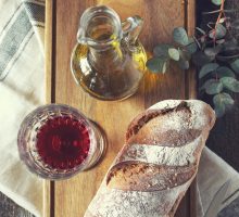olive oil and wine and a country style loaf of bread