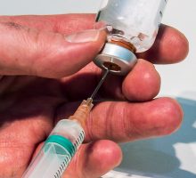 filling a syringe with medicine