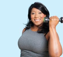 Overweight woman exercising and lifting weight