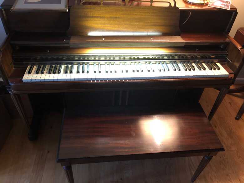 Lovely piano with storage bench