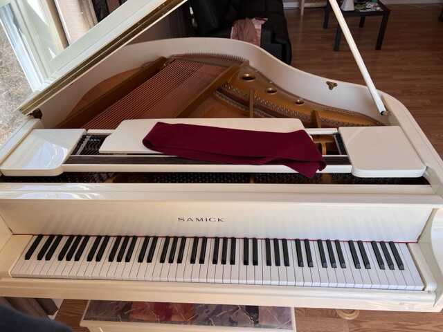 A White Samick Baby Grand Piano