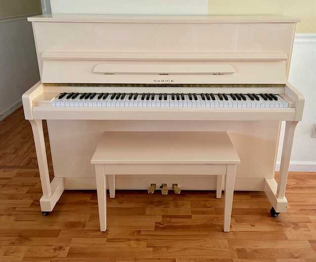 Upright Ivory piano for sale. Tuned in excellent condition