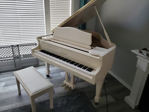 Ivory baby grand piano 