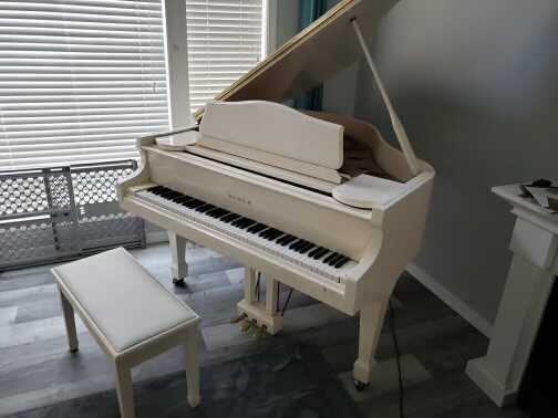 Ivory baby grand piano 