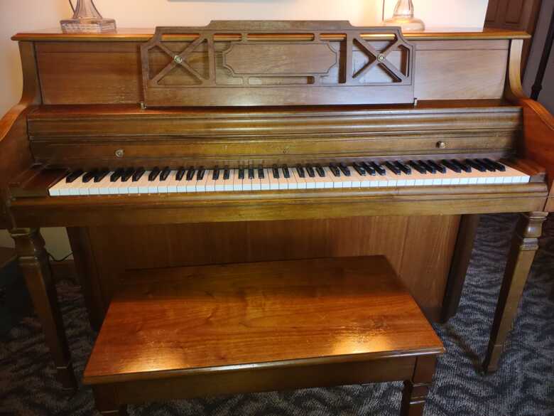 1980s Wurlitzer piano with bench.