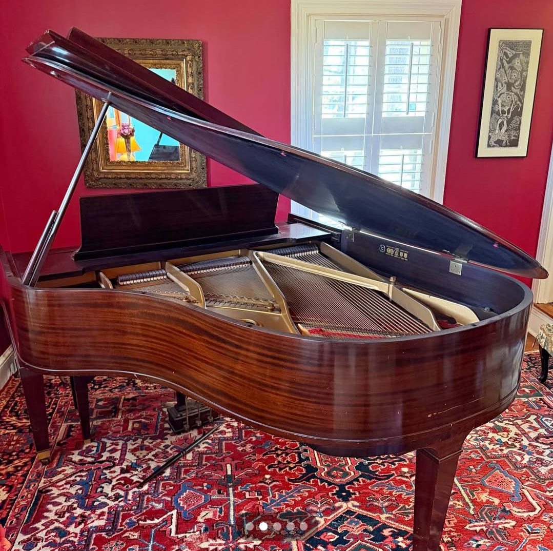 Beautiful Baldwin baby grand piano in elegant walnut finish.