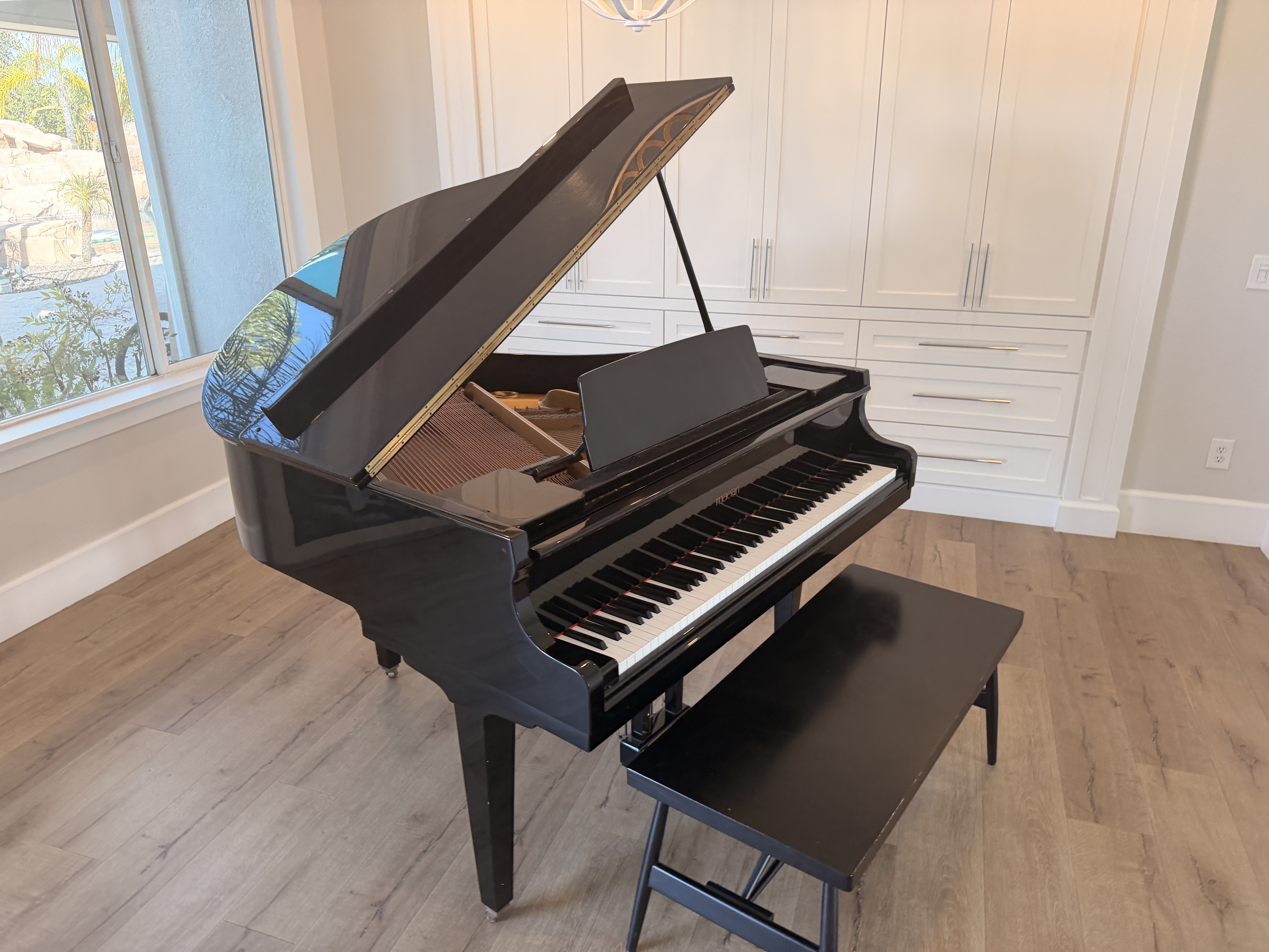 Beautiful Maeari baby grand piano in polished ebony