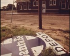 ABANDONED_SANTA_FE_DEPOT_SIGN_WHICH_ONCE_BECKONED_TRAVELERS_AT_HALSTEAD__KANSAS__NOW_RUSTS_IN_WEEDS_BEHIND_THE..._-_NARA_-_556013.jpg