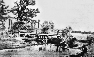 First_Bridge_Over_Cane_Island_Creek_circa_1895.jpg