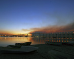 US_Navy_071023-N-5491S-001_The_sun_rises_over_the_Coronado_Bay_Bridge_with_smoke_from_the_Harris_fire_looming_overhead.jpg