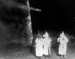 Ku_Klux_Klan_members_and_a_burning_cross__Denver__Colorado__1921.jpg