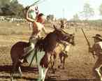 A_young_boy_on_horseback__recreating_the_Indian_Raid_during_the_Flax_Scutching_Festival.jpg