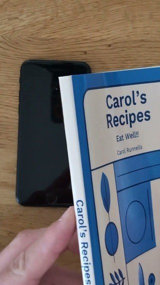 Blue perfect-bound cookbook showing its cover and printed spine