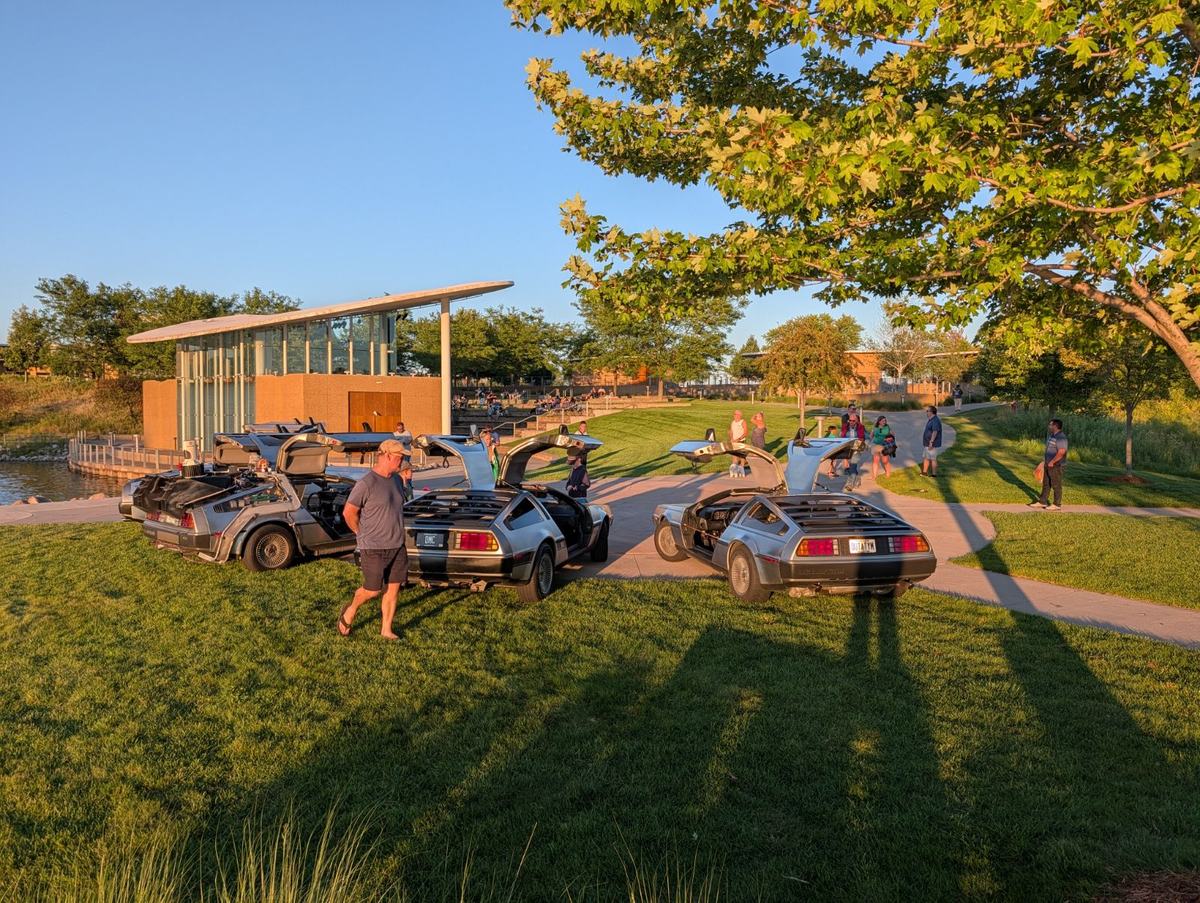 Multiple DeLorean rear ends parked in a row