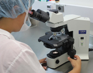 Scientist at microscope
