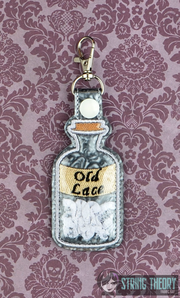 Old Lace Bottle Trapped Snap Tab Key Fob