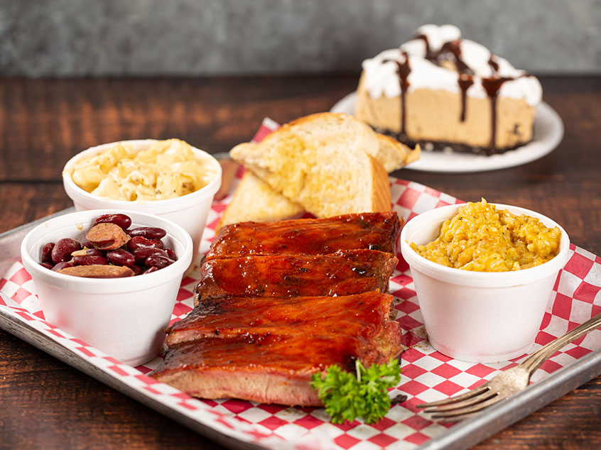 A plate of BBQ in Savannah with ribs, southern sides, and desert.