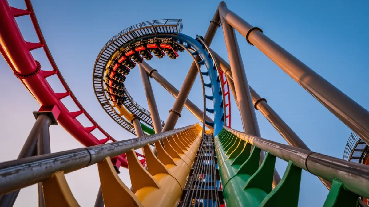 Close-up of rollercoaster track spiral against golden-hour sky