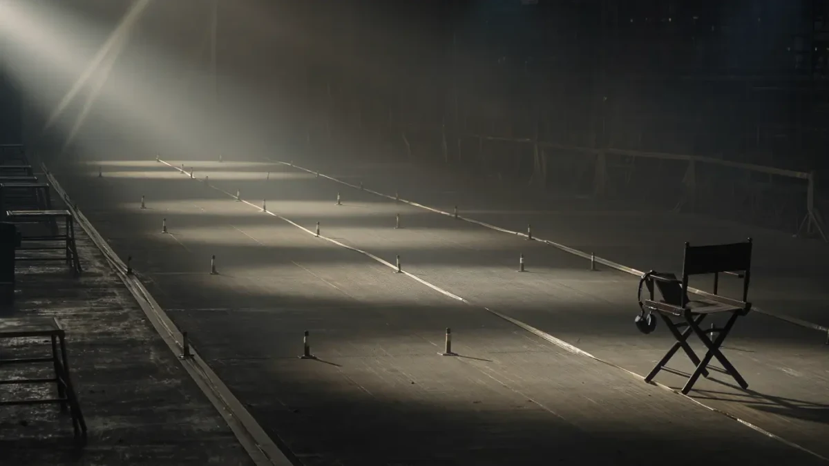 Empty runway at dusk with light beams and timing tape marks on the floor