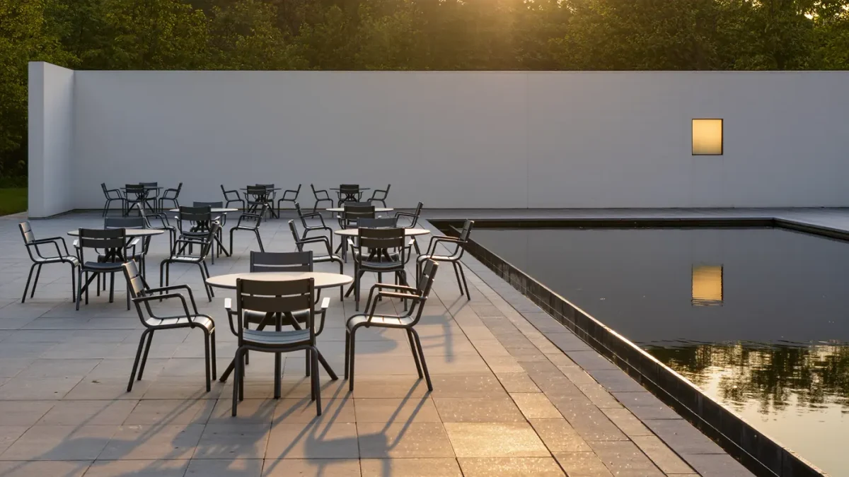 Empty chairs in a morning sculpture garden corner