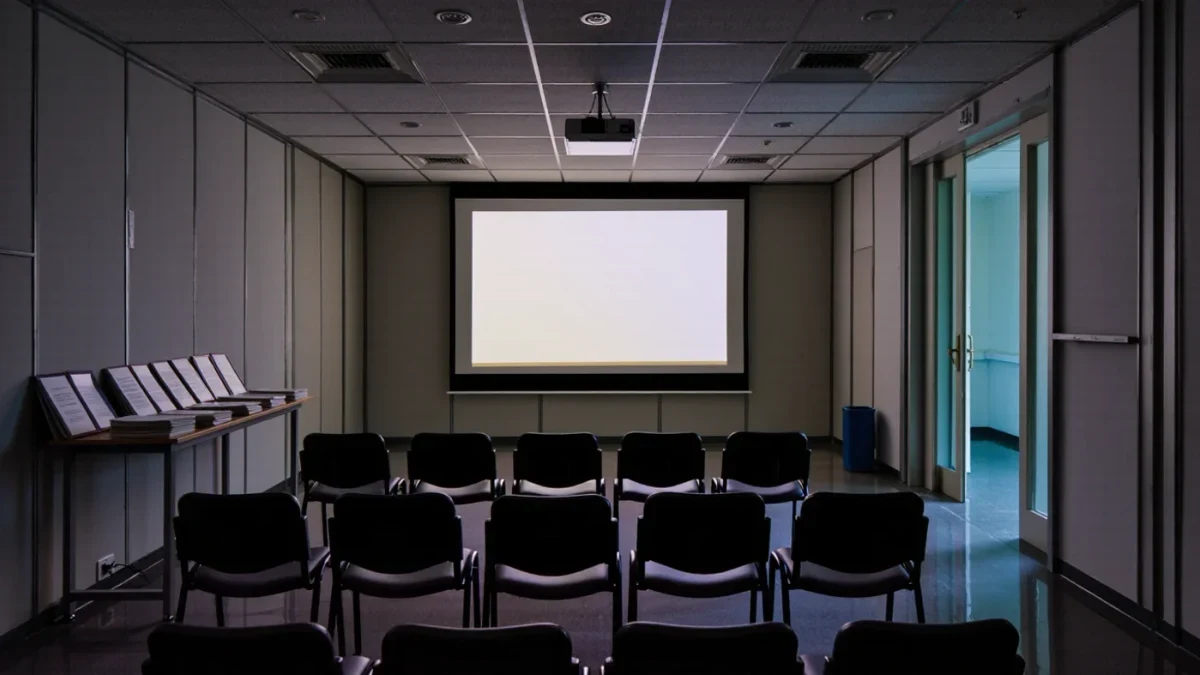 Empty production office screening room with dim projector light