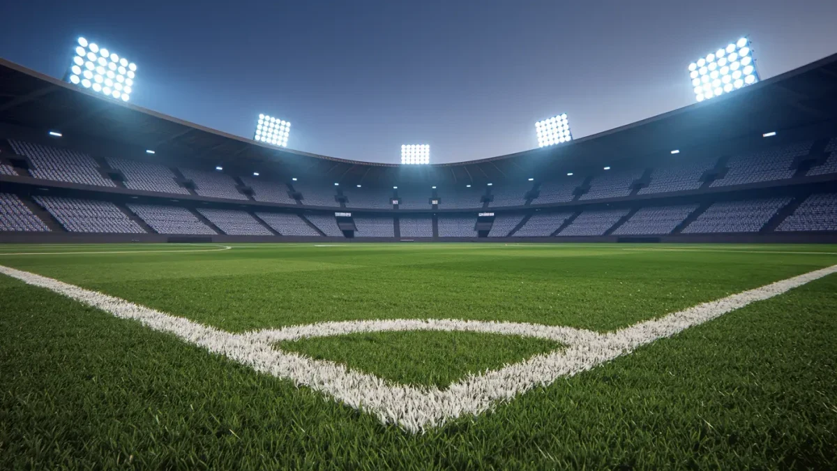 Empty stadium pitch under evening lights before a match