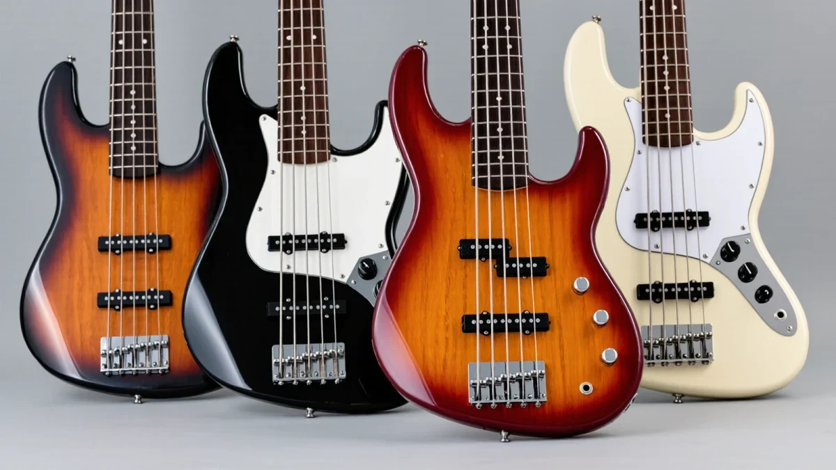 Close-up of four budget electric guitar headstocks and pickups
