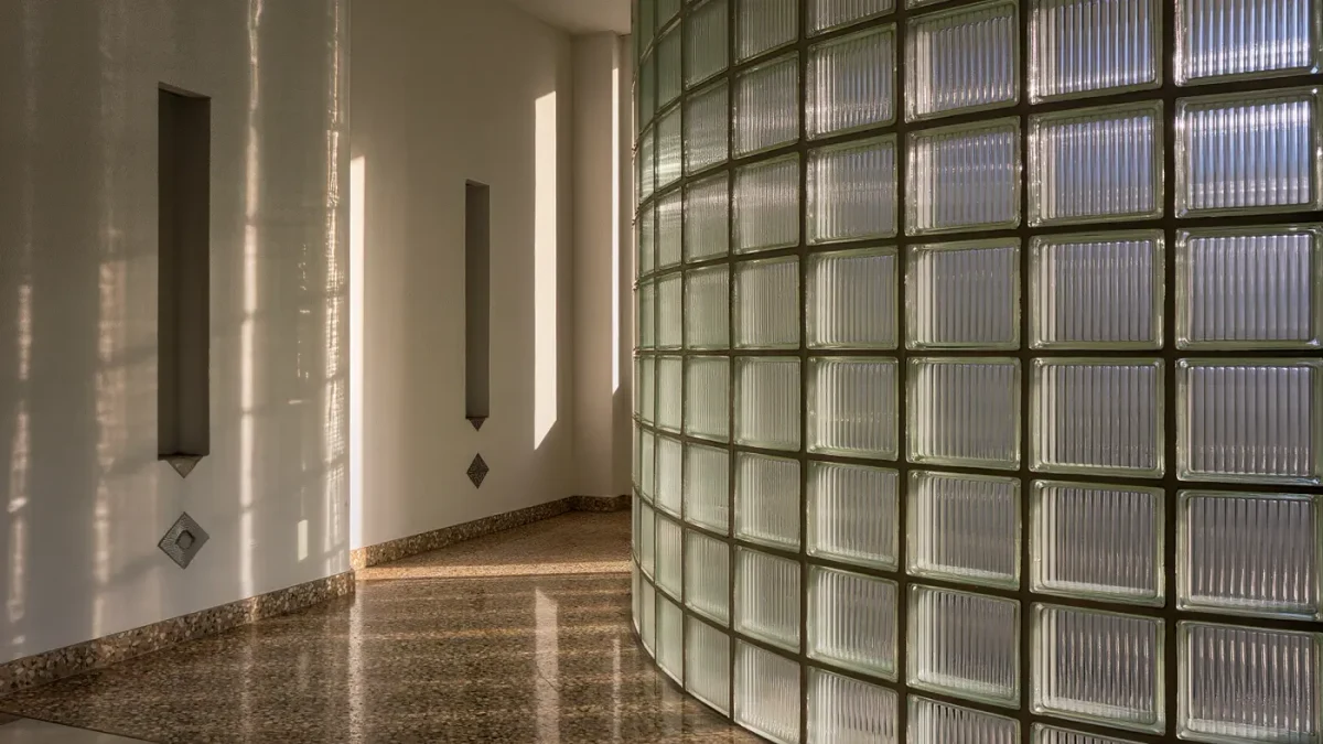 Curved glass block wall glowing with afternoon light