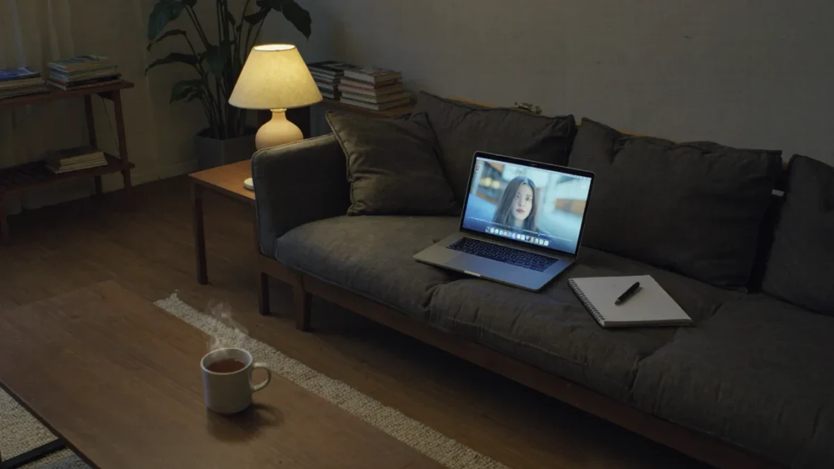 Living room at night with laptop and notebook on couch