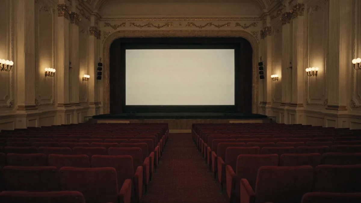 Empty cinema auditorium with divided red seating sections
