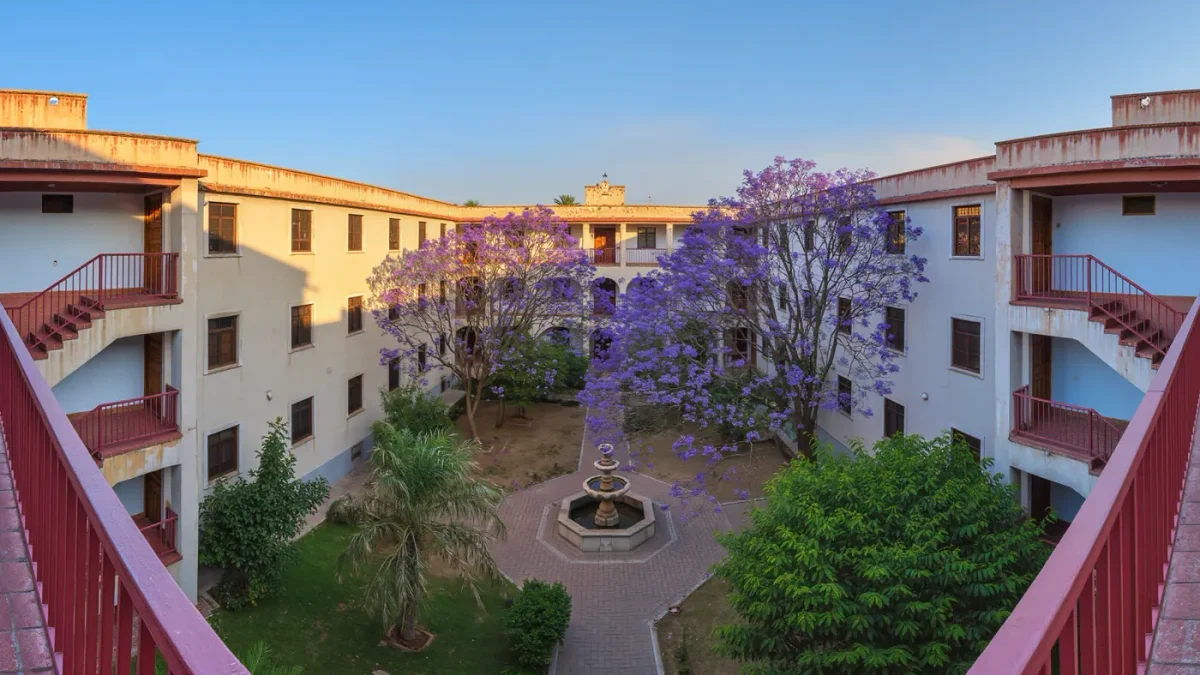 Two-story courtyard apartment building with shared garden