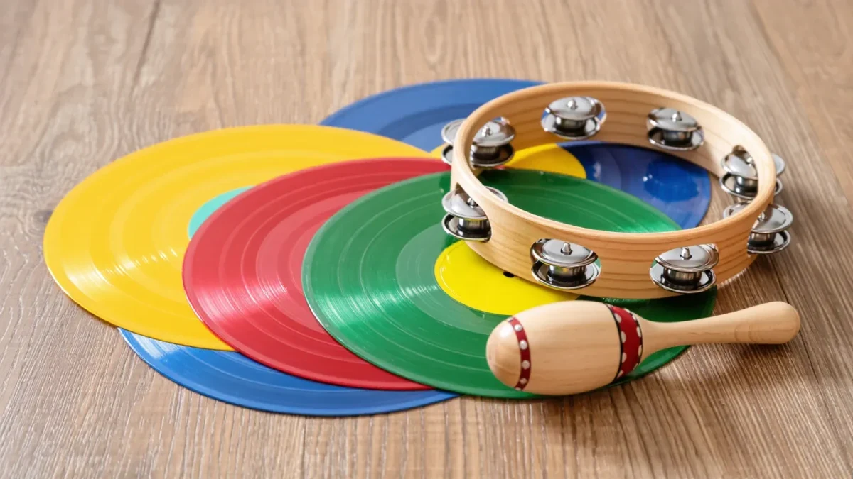 Studio close-up of colorful vinyl records and small tambourine