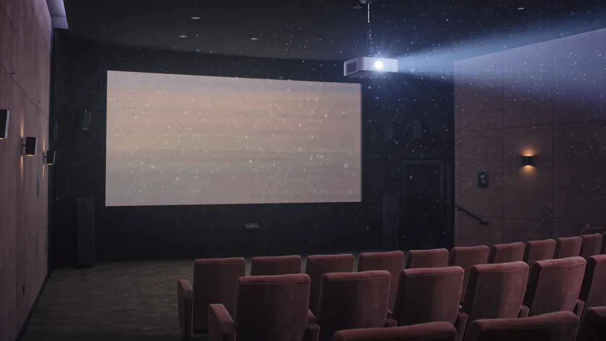 Empty screening room with a paused premiere on the screen