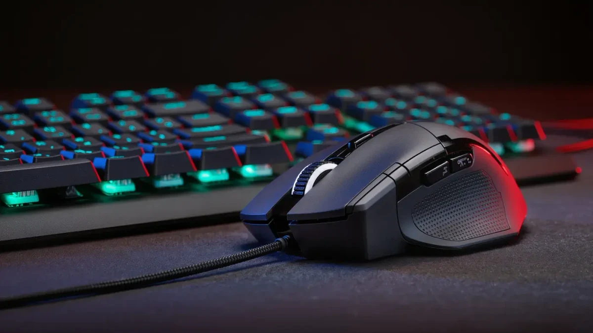 Close-up of a gaming mouse and mechanical keyboard in stadium light