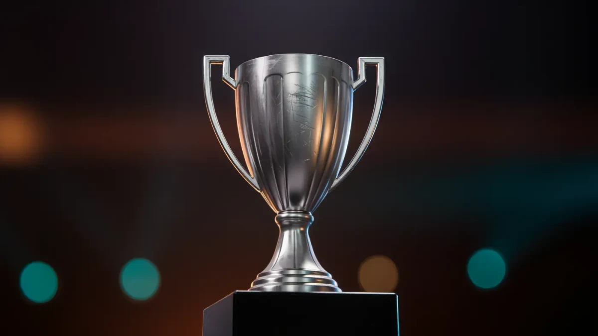 Trophy on a stage pedestal lit by arena spotlights at night