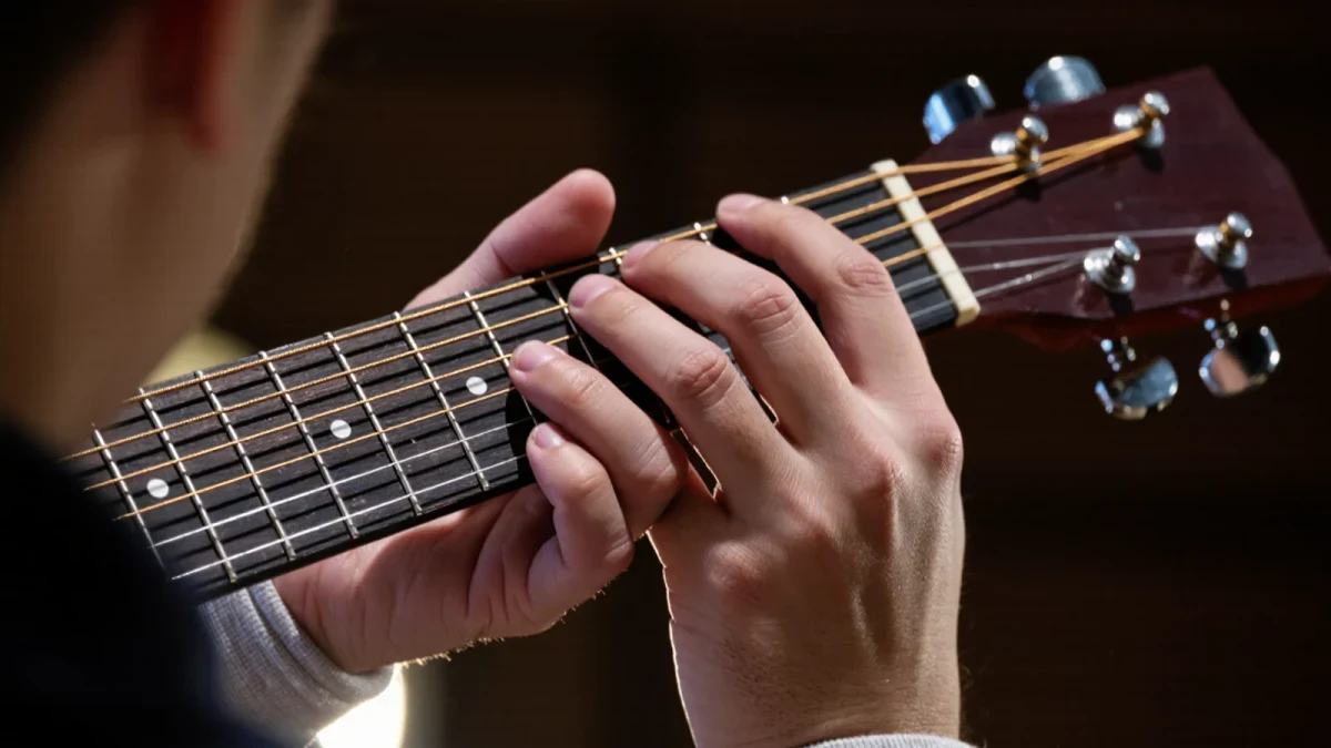Both hands on an acoustic guitar fretboard mid two-hand tap