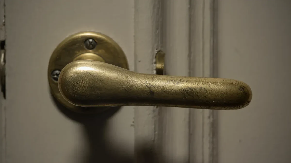 Polished brass handle on a gallery door, close-up detail