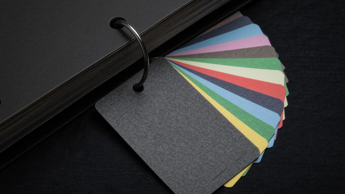 Close-up of structured index cards feeding a quarterly report binder