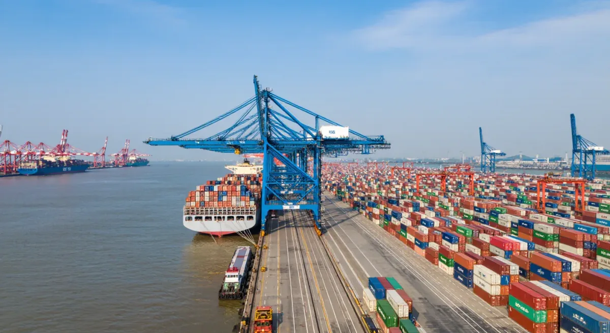 Containers and cranes at a large Mediterranean port at midday