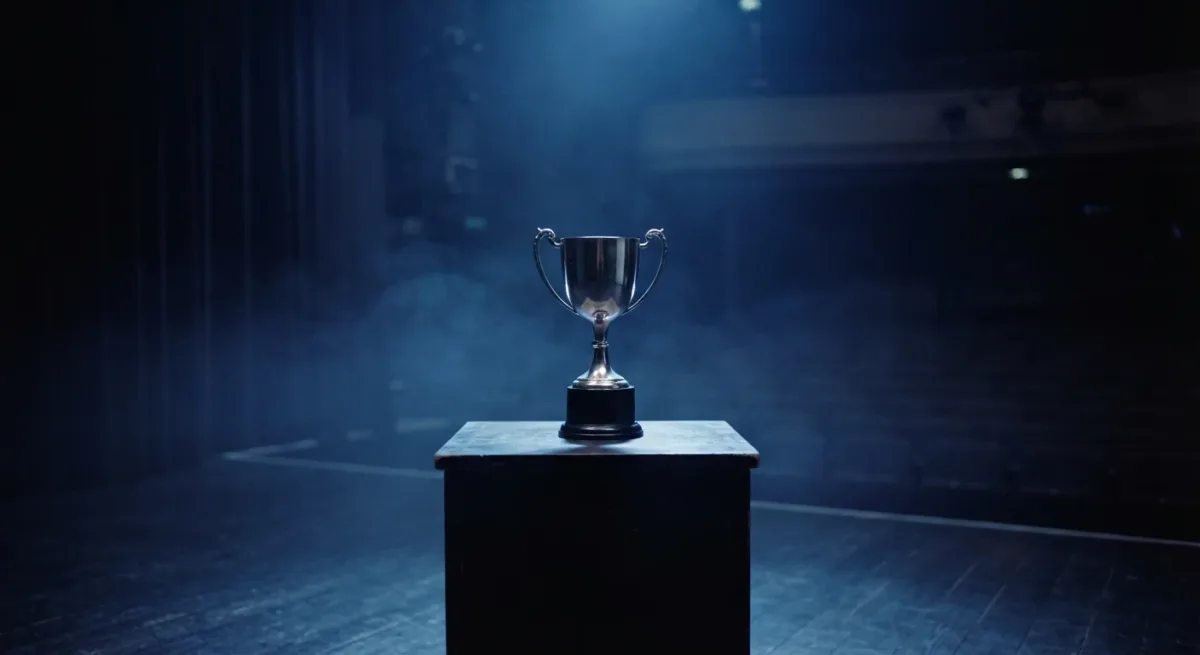 Trophy on a stage pedestal under blue spotlights