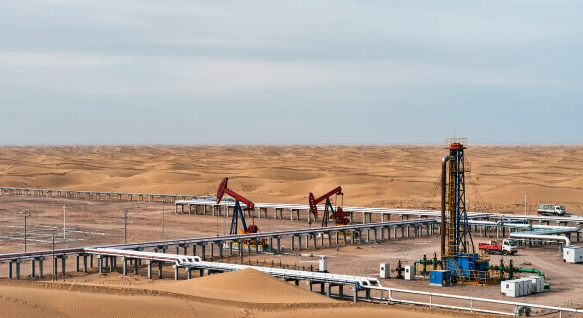 Pumping equipment at an oil facility under a wide sky