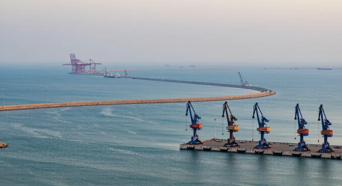 Quay wall and breakwater of an Omani industrial port at dawn