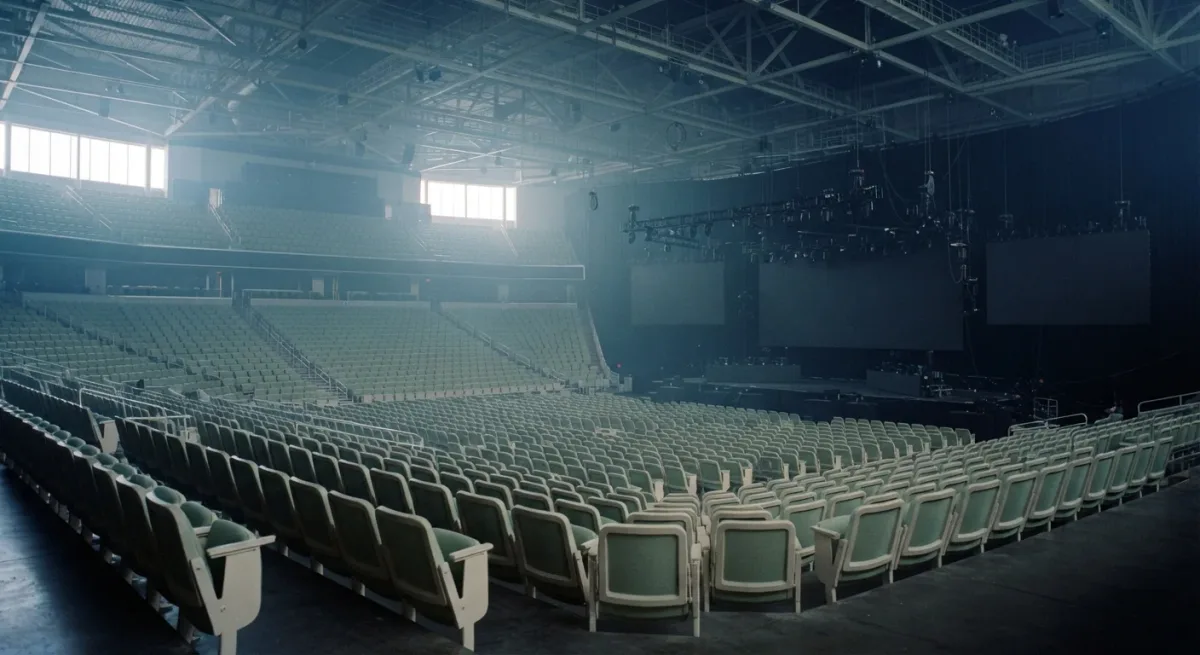 Empty esports arena with stage rigging in blue haze