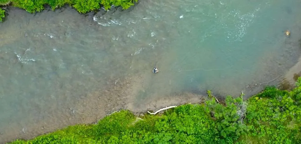 Western Ranch Brokers Caleb Campbell fly fishing in a stream on a Montana ranch for sale