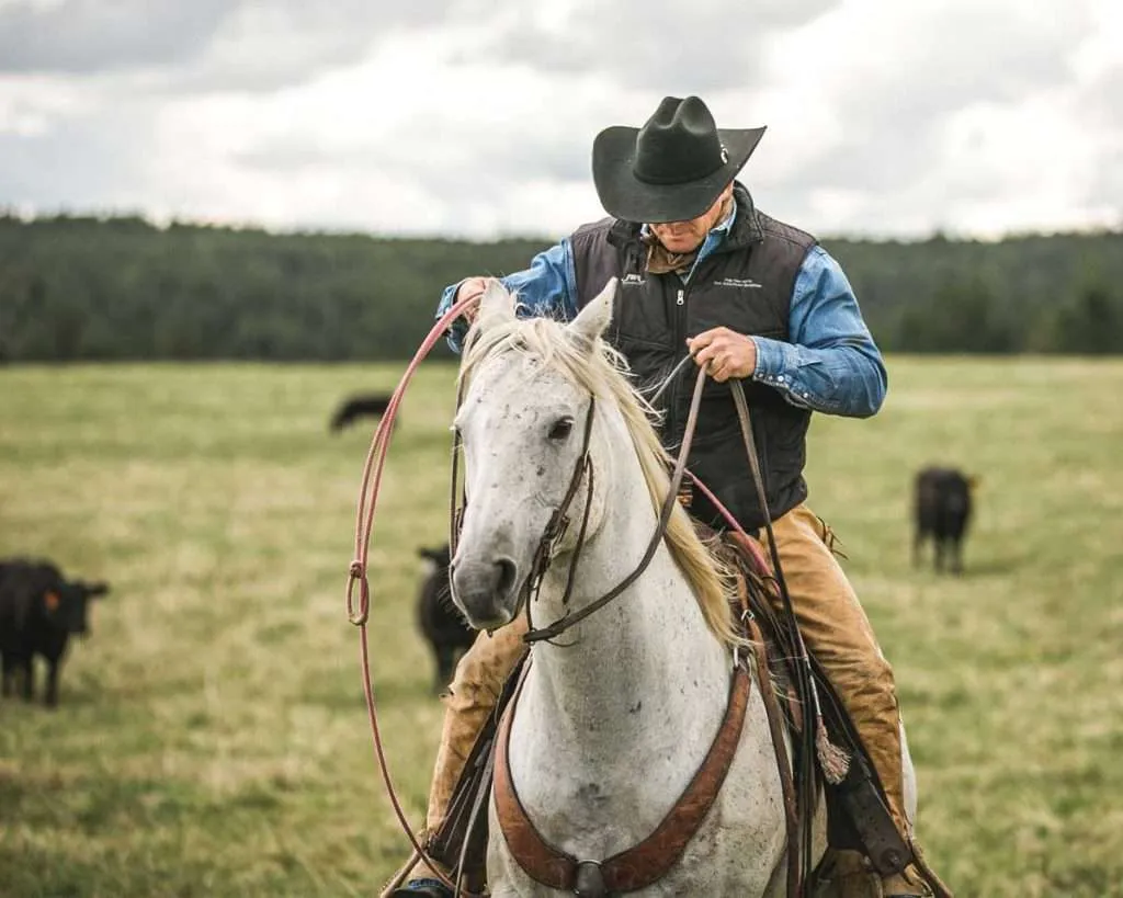 Ranch broker Bill Boyce on horseback