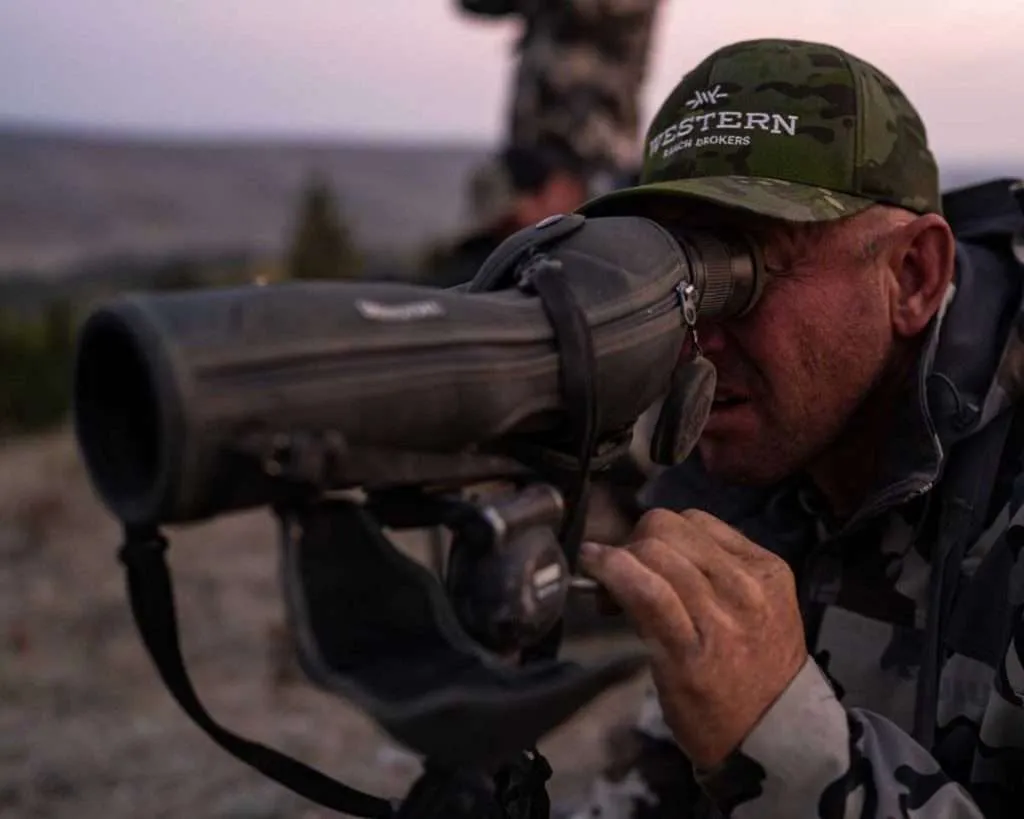 Ranch broker Bill Boyce looking through a scope